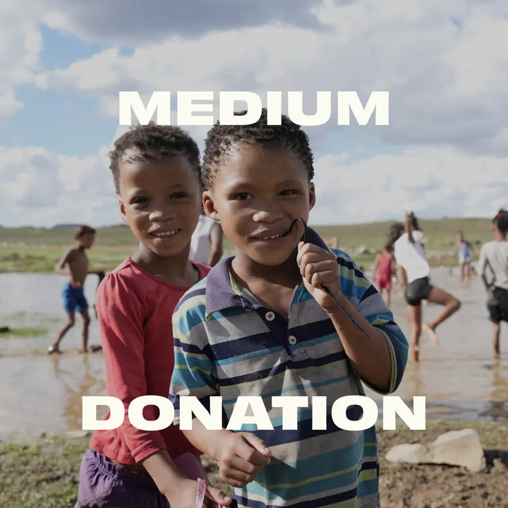 Two children standing by a body of water with text overlay 'MEDIUM DONATION'.